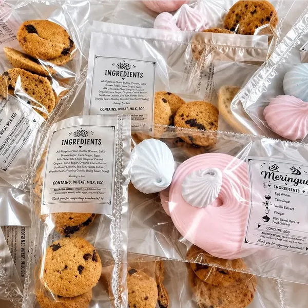 Individually wrapped cookies and meringues with printed ingredient labels.